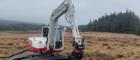 A digger on peat in the Antrim Hills, Northern Ireland