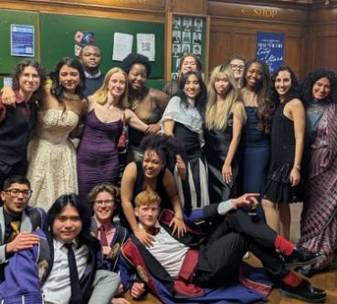 Image of a group of people in their late teens/early 20s smiling and dressed in nice/smart clothes