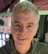 A head and shoulders portrait shot of Professor Simon Milling