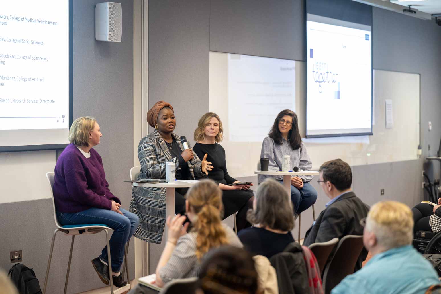 A panel of women in front of an audience