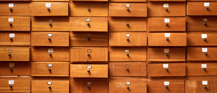 Packed wall of wooden drawers