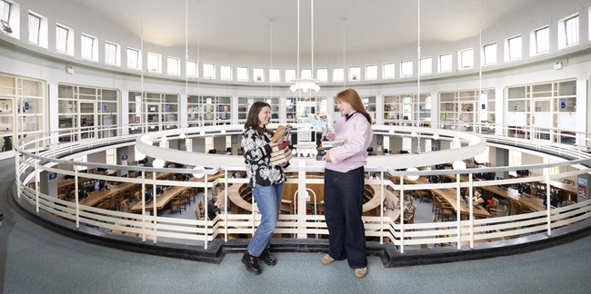 Jodie Pike (report author and Humanities student intern) and Tessa Carroll (Humanities student intern) at the McMillan Reading Room, University of Glasgow.