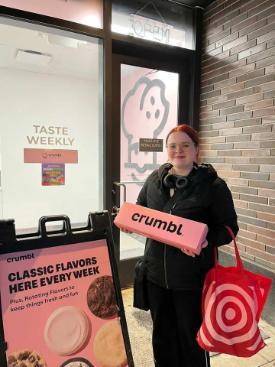 Young female student holding a sign in a cafe
