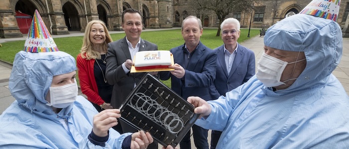 (centre l-r) JWNC director of strategy Evelyn Toma, JWNC director Professor Martin Weides, Sivers Semiconductor CTO Andrew McKee and Kelvin Nanotechnology CEO Brendan Casey are flanked by JWNC staff in cleanroom suits holding laser components developed by Sivers and manufactured in partnership with the JWNC. The JWNC staff are Claire Goodwin (left) and Mark Dragsnes (right).