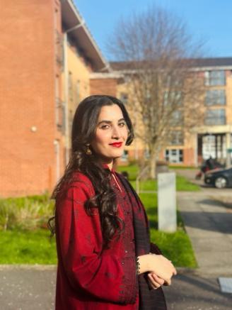 Woman with long dark hair smiling at the camera