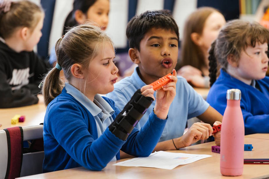Two school children with shapes