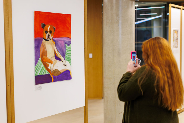 A visitor takes a photo of an artwork in the ARC on their phone