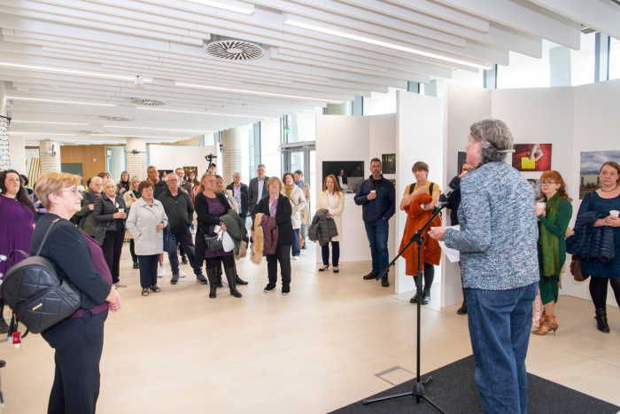 Audience members listen to a speaker at the Cost of Dying event in the ARC