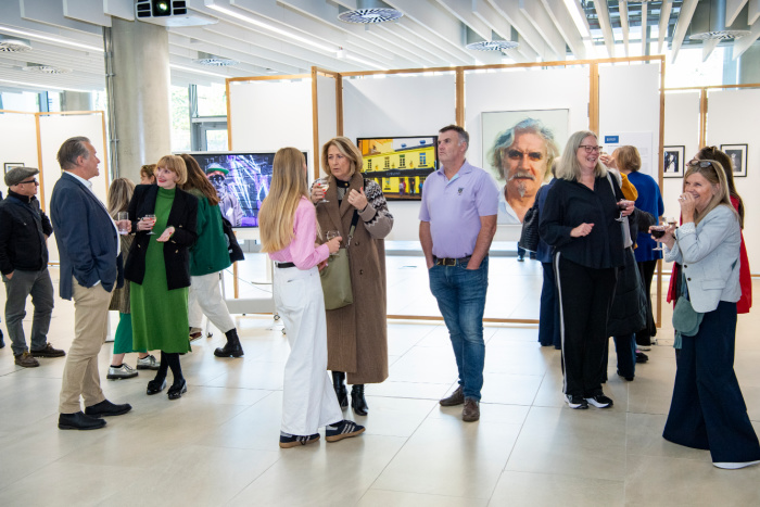 Attendees chat at the Iain Clark photography exhibition