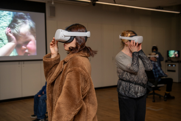 Visitors wear VR headsets at the Tell Tale Rooms event in the ARC