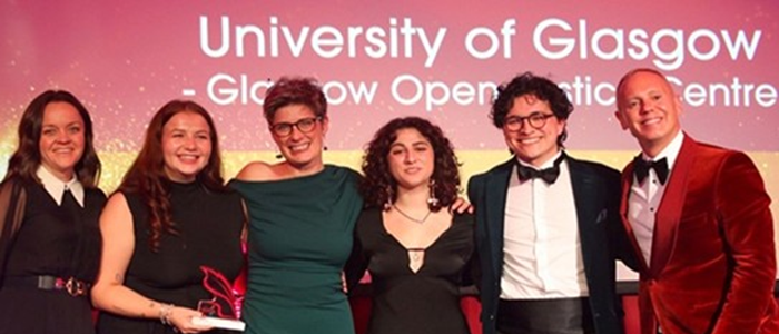 Staff and students from the GO Justice Centre stand next to Judge Rob Rinder to receive their award