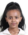 A young woman wearing a white collared top and with dark hair tied up