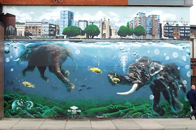 A mural depicting a pair of elephants swimming under water