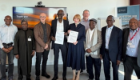 Delegates from the University of Glasgow and Ahmadu Bello University (ABU), Nigeria, stand together following the signing of a Memorandum of Understanding (MoU). At the centre, Professor Ahmed Adamu, Vice Chancellor of ABU, and Professor Rachel Sandison, Deputy Vice Chancellor for External Engagement and Vice Principal for External Relations at the University of Glasgow, hold the signed agreement documents. They are joined by Professor Harry de-Koning and other representatives from both institutions during the visit to the University of Glasgow in April 2026.