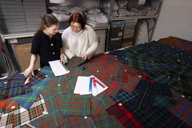 UofG students Layla (left) and Lilly (right) exam tartan samples. Credit Duncan McGlynn Two students examine tartan samples. Credit Duncan McGlynn