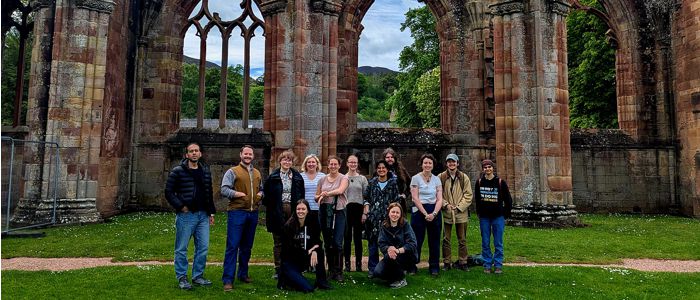 Group shot showing Melrose Abbey in the back ground