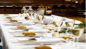 A rectangular top table set for a wedding breakfast in Bute Hall.