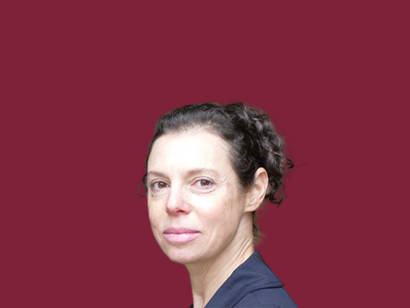 Headshot of Melea Press on a solid burgundy background