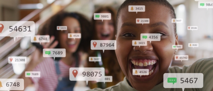 Image of social media icons and text over happy female friends vlogging at home. global connections, digital interface and communication