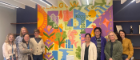 GO Justice Centre staff stand before the new mural in the main centre space