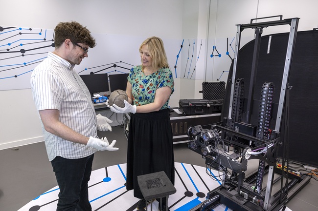 Professor Neil McDonnell and Kirstie Campbell at the Advanced Research Centre. Credit Martin Shields A man and woman get the world's oldest football ready for scanning in 3D. Credit Martin Shields