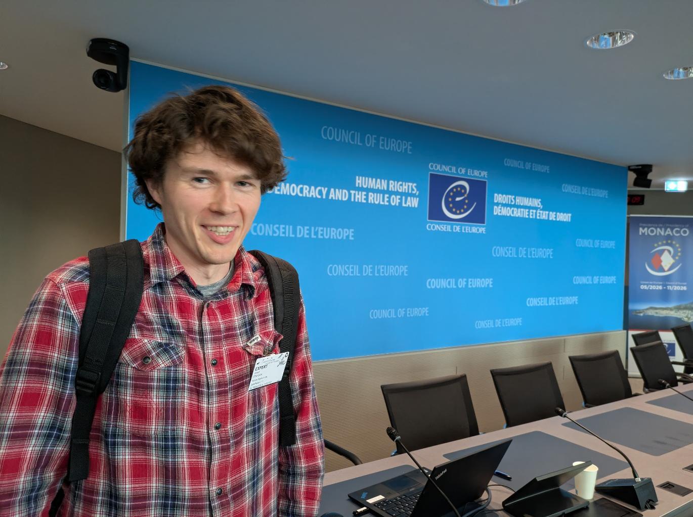 Person standing in front of a banner