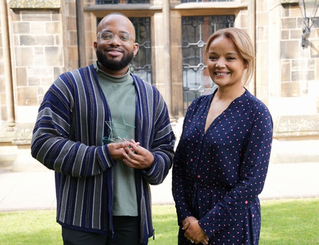 Steveen Ulysse received his award from Dr Susie Mitchell. Credit Jacquie Dunbar A man holding a glass star shaped award with a woman by his side at the University of Glasgow. Credit Jacquie Dunbar