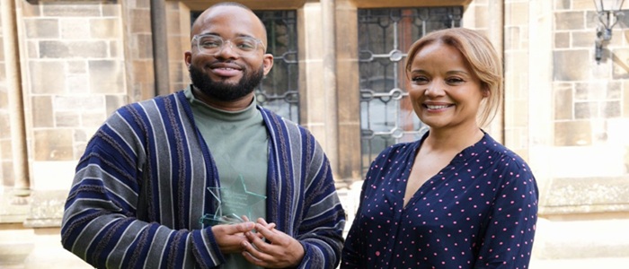 A man holding a glass star shaped award with a woman by his side at the University of Glasgow. Credit Jacquie Dunbar