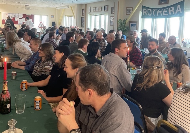 A group of people enjoy a Burns Supper at Rothera Research Station, Antarctica