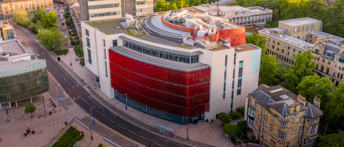 An aerial drone shot of the James McCune Smith building and University Avenue