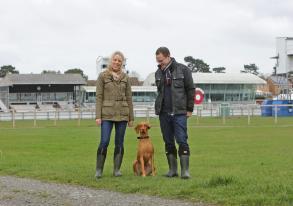 Amber and her owners outdoors on a walk