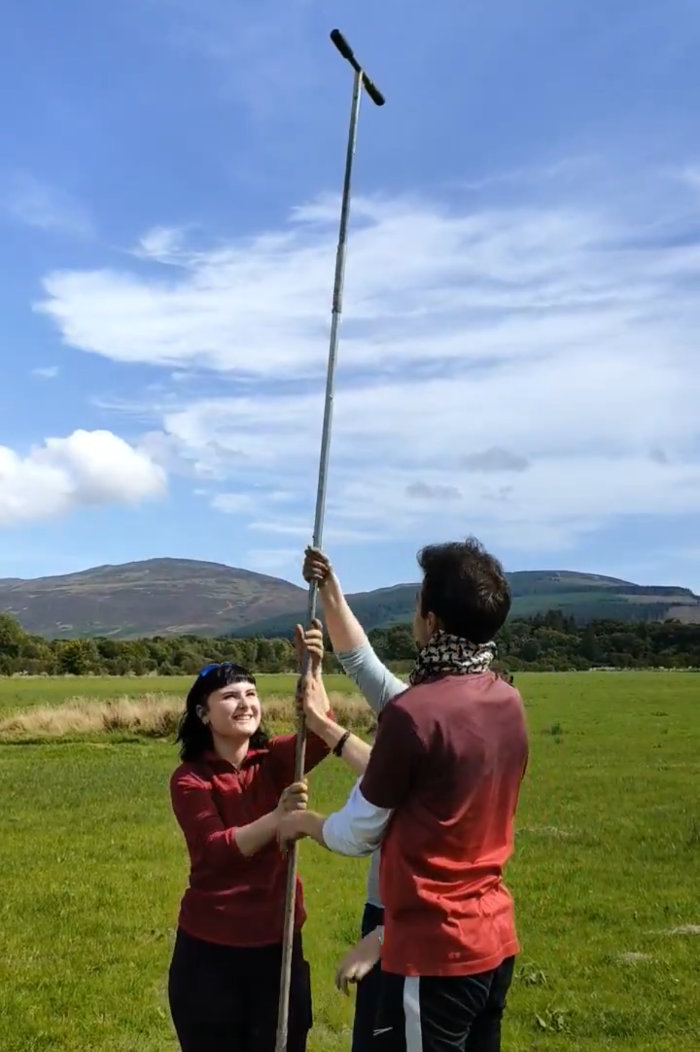 Two students using coring equipment
