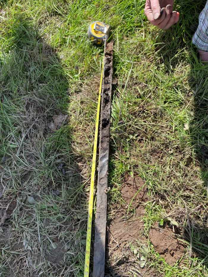 Sediment core with hand tape running alongside for scale
