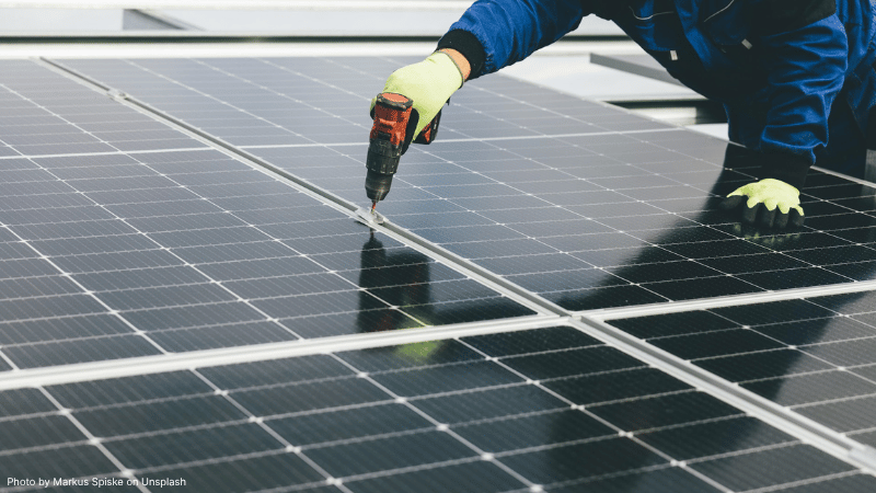 A person working on a solar panel
