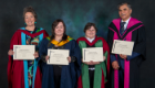 Professor Olwyn Byron, Miss Bethany Mansfield, Dr Lesley Hamilton and Professor Adnan Al-Hindi pose with their University of Glasgow Teaching Excellence Award certificates after receiving recognition for the Practical Resources for Gaza Students (PRGS) initiative at the 2026 graduation ceremonies.