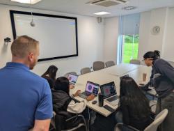 4 students using laptops to view molecular graphics. 2 staff demonstrators are stood