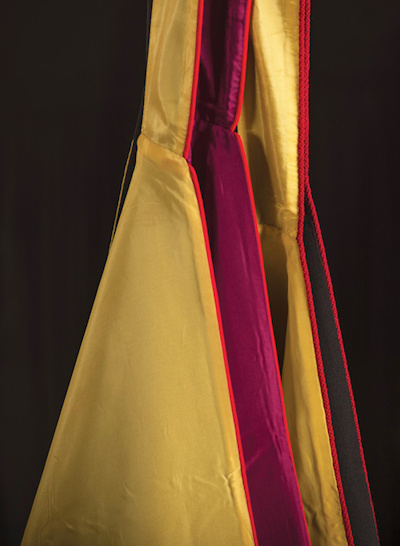 A close up shot of a black, yellow and red graduation gown