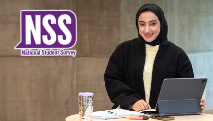Student studying with a tablet in the James McCune Smith Learning Hub. The National Student Survey (NSS) logo is overlaid on the image.