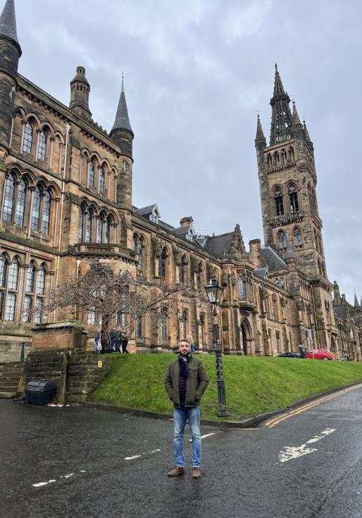 Photo of Tasnim Alam in front of University of Glasgow Tower