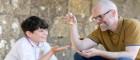 Fergus with the University of Glasgow’s Dr Gareth Beale holding a replica Viking era scales