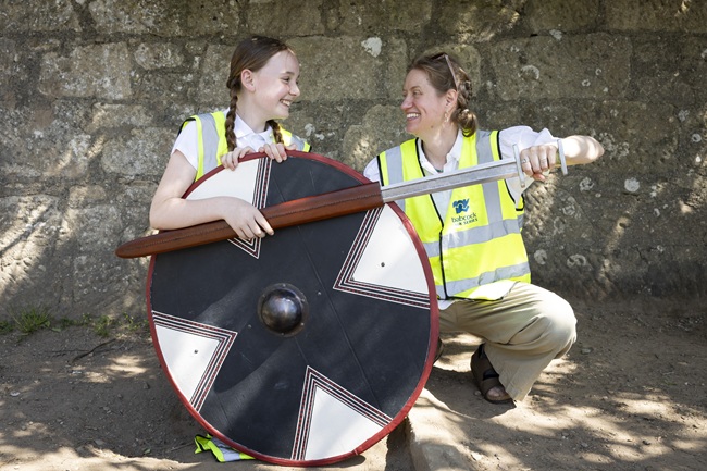 0Eliza from Hermitage Primary holding a replica Viking shield with University of Glasgow’s Dr Nicole Smith