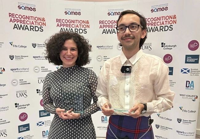 Dr Zahra Khosroshahi andDr Kevin Leomo with their SAMEE Award 2026 A man and woman holding a glass award in each of their hands