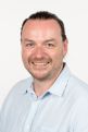 A portrait photo of Andrew McHugh