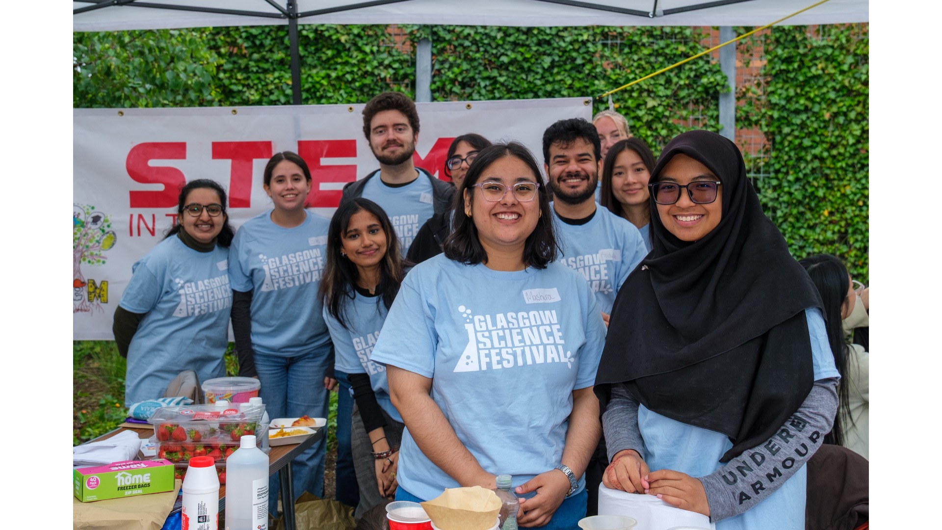 Photograph of a group of people with Glasgow Science Festival branded t-shirts.