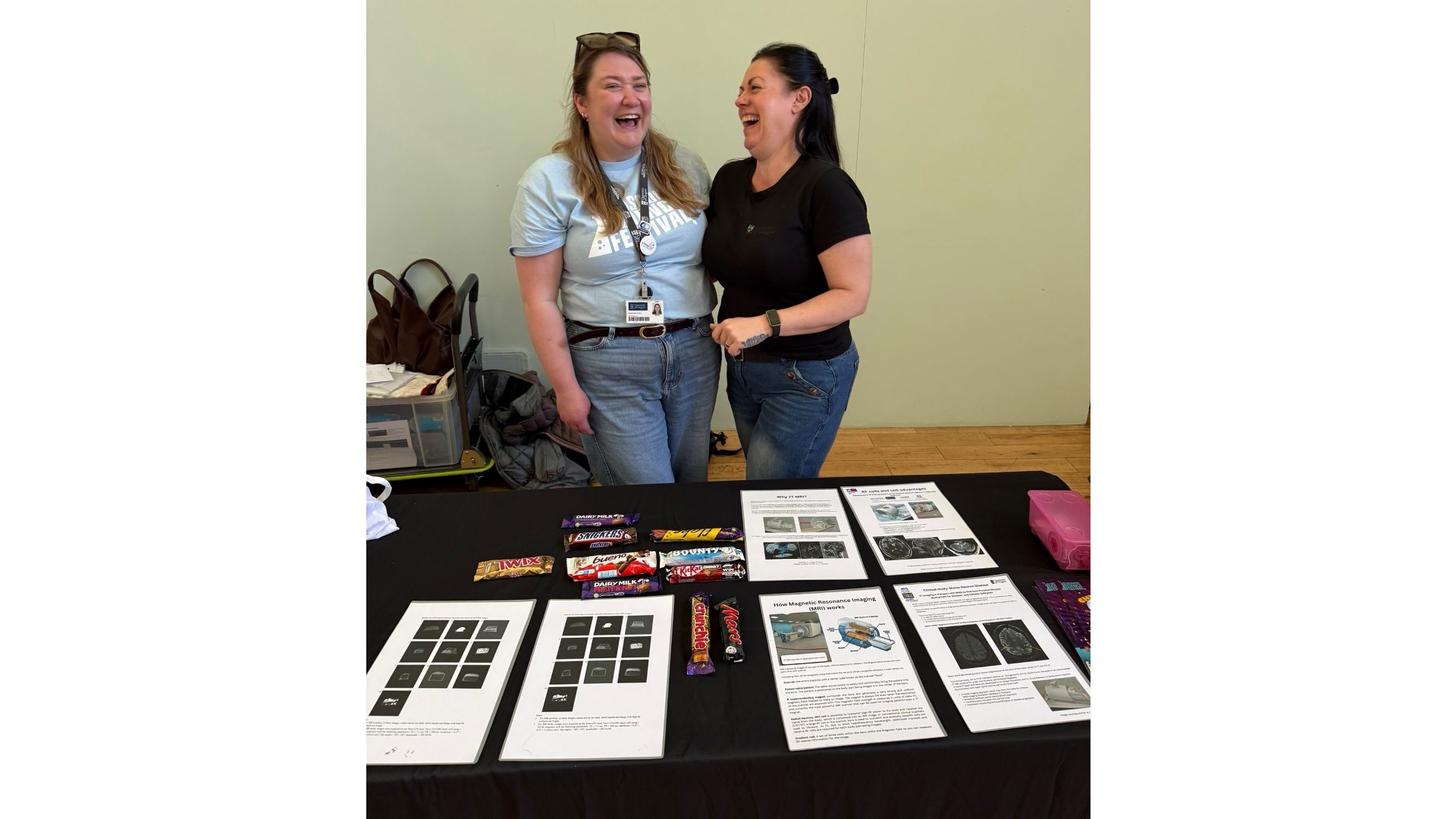 Photograph of two people at a stand with flyers and activities.