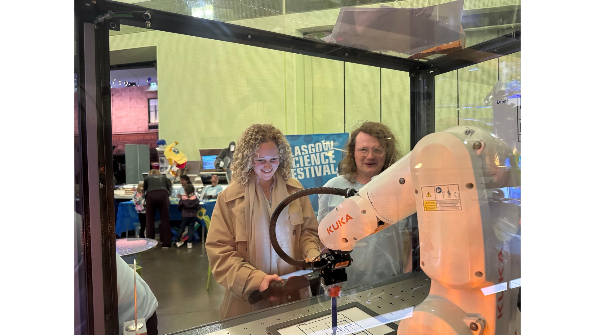 Photograph of a GSF volunteer with a woman and a robot.