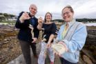 From left to right, Gillebrìde MacMillan, Dr Claire Ramjan and Dr Anna McGregor celebrate Project Eisirean in Millport where the new mobile oyster hatchery is based.