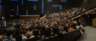A large conference of people sitting in a massive lecture hall