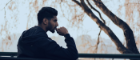 A man sitting on a bench, deep in thought