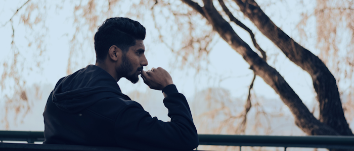 A man sitting on a bench, deep in thought